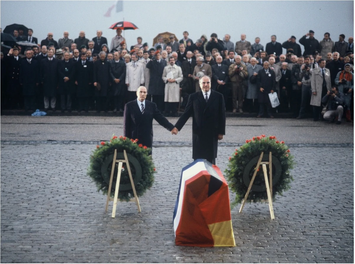 Soru 235 için görsel: Fransa Cumhurbaşkanı François Mitterrand ve Alman Federal Şansölyesi Helmut Kohl, Verdun'da iki dünya savaşında ölenleri birlikte anıyor. Bu buluşmada Avrupa Birliği'nin hangi hedefi açıkça görülüyor?